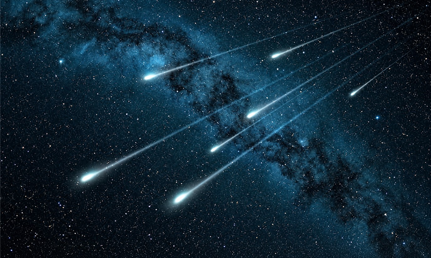 A meteor shower crossing a clear night sky